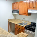 Balcones Terrace apartment kitchen with granite countertops and black appliances